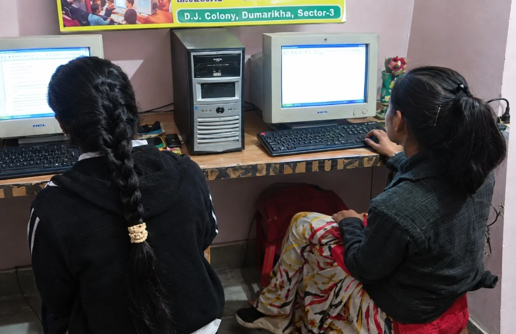 Students practicing on desktop computers in a digital literacy class